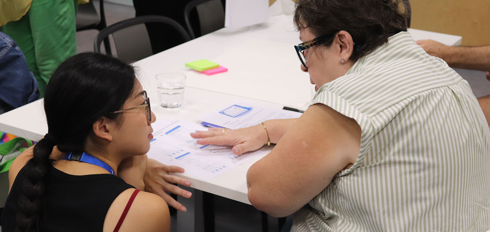 A Helix software engineer speaks to a member of the public about an app design