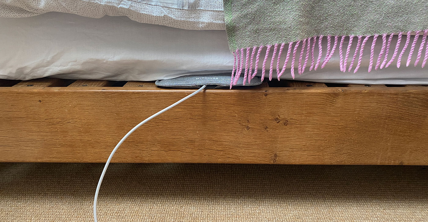 A sleep sensor installed under a mattress